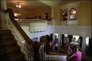 Visitors take in the grand staircase off of the main entrance while on a tour of the Edward D. Libbey House.