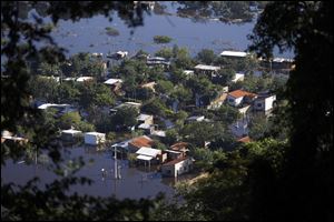 Homes are surrounded by floodwater in the Cateura neighborhood, seen from Lamabare Hill in Asuncion, Paraguay.