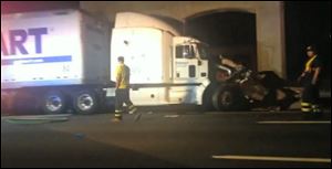 In this image from video the Wal-Mart truck involved in the crash of the limousine bus carrying Tracy Morgan and six other people is seen early Saturday morning on the New Jersey Turnpike at the accident scene. 