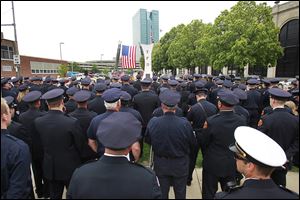 A throng of police officers and firefighters look on during the annual memorial service in Chub DeWolf Park.