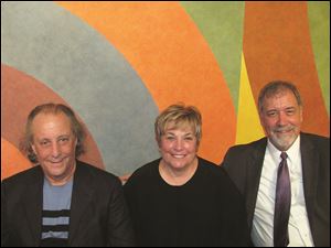 From left, Stuart and Maxine Frankel, and Martin Porter in front of a Sol LeWitt mural. 
