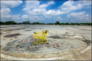 A shopping cart occupies a spot at the site of the demolished North Towne Square Mall along Alexis Road.