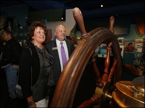 Dawn and Gary Sartain look at a wheel from the Tashmoo during the opening reception for the National Museum of the Great Lakes, April 25, 2014.
