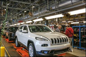 Fully assembled Jeep Cherokees roll along the line at the Toledo Assembly complex. Chuck F. Padden, plant manager, said: ‘‍[This facility] will be one of the largest manufacturing sites in North America with both plants running full tilt,’‍ referring to the two Jeep models built there, the Wrangler and the new Cherokee. 