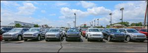 Jeep Cherokees are lined up outside Yark Automotive in Toledo. The dealership says the new Cherokee has become its best-selling Jeep.