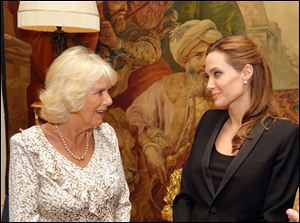 Camilla, Duchess of Cornwall, left, meets Angelina Jolie, as the actress talked about her campaign against sexual violence in war zones during a meeting, at Clarence House, London.