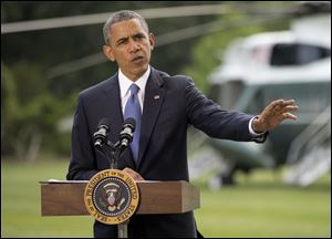 President Barack Obama talks about his administration's response to a growing insurgency foothold in Iraq today on the South Lawn of the White House in Washington.