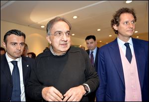 Fiat Chairman John Elkann, right, and Fiat and Chrysler CEO Sergio Marchionne arrive for a meeting with shareholders earlier this year in Turin, Italy.