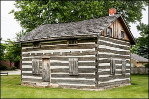 The historic log house will be the last stop of the Whitehouse sesquicentennial parade featuring many floats on July 5.