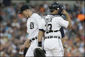 Detroit Tigers pitcher Max Scherzer leaves the mound after being relieved as Alex Avila (13) looks on against the Kansas City Royals in the fifth inning.