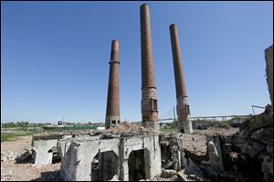 The downtown Toledo skyline is visible behind the remains of the former Acme power plant in the Marina District.