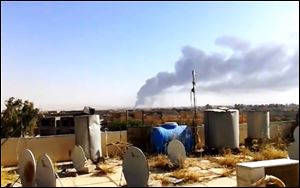 Smoke rises after an attack by al-Qaeda-inspired Islamic State of Iraq and the Levant militants on the country’s largest oil refinery in Beiji, Iraq on Tuesday.