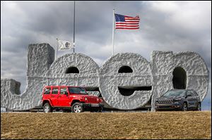 A Rubicon, left, and a 2014 Jeep Cherokee are on display at the Chrysler Toledo Assembly Complex in Toledo.