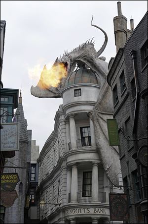 A dragon atop Gringotts Bank breathes fire. The area has just one ride, but it boasts seven shops where Muggles can buy butterbeer ice cream and wands.