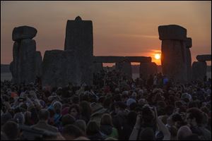 The sun rises as thousands of revelers gathered today at the ancient stone circle Stonehenge, near Salisbury, England, to celebrate the summer solstice, the longest day of the year.