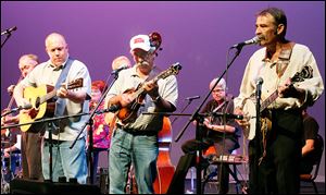Flatland Grass, including David Moore, left and partially obscured, on fiddle; Shaun Miller on guitar; Neil Hensley on mandolin, and Tim Ellis on banjo, take part in ‘‍Eddie Boggs: A Tribute of Song.’