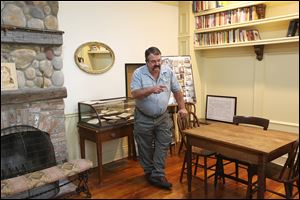 J.D. Justus, Perrysburg Area Historical Museum board member, discusses features of one of the restored rooms in the Spafford House Museum at 27340 River Road just west of Fort Meigs. 