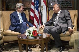U.S. Secretary of State John Kerry, left, meets with Egyptian Foreign Minister Sameh Hassan Shoukry today at a hotel in Cairo.
