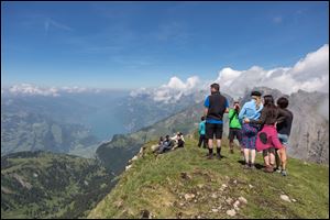 Hikers enjoy the view from the Alvier mountain  in the Swiss Alps near Truebbach , Switzerland, Saturday.