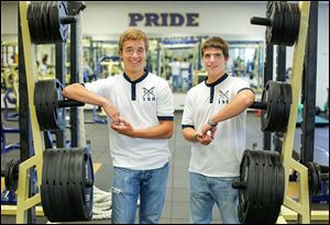 James Miller, left, and Bailey O’Brien, in the weight room at St. John’s Jesuit High School, will attempt to break the world record for consecutive hours rowing on one machine. The record is 40 hours. 