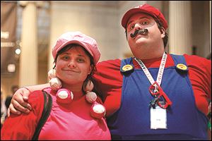 Nicole Klatt, left, dressed as Toadette, and Bill Carter, right, dressed as Mario, enjoy the video game inspired exhibit. 