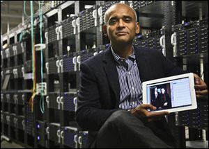 Chet Kanojia, founder and CEO of Aereo, Inc., holding a tablet displaying his company's technology, in New York.