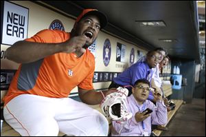 Houston Astros relief pitcher Jerome Williams, left, cheers as he and reporters watch the World Cup soccer match between the United States and Germany before the baseball game between the Astros and the Atlanta Braves today in Houston.)