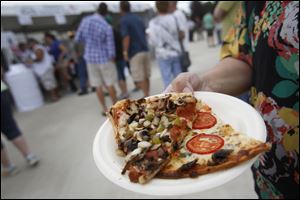 Slices of pizza fill a plate at last year’s Pizza Palooza at Centennial Terrace in Sylvania. This year’s event will be July 25-26.