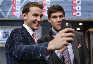 Michigan's Nik Stauskas, left, and Creighton's Doug McDermott pose together for a selfie before the start of the 2014 NBA Draft tonight in New York.
