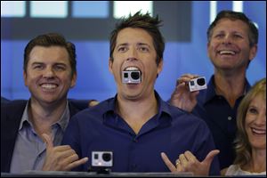GoPro's CEO Nick Woodman holds a GoPro camera in his mouth as he celebrates his company's IPO at the Nasdaq MarketSite  today in New York.