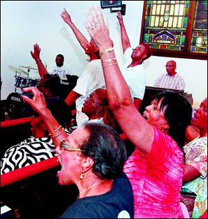 Members of the Toledo Interfaith Mass Choir rehearse at the St. Paul AME Zion Church in Toledo.