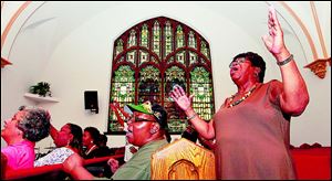 Alto Pearl Humphrey, right, raises her voice during the rehearsal.