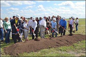 Larry Dillin, at far right with a shovel, is still sought after in his new community in Austin. He became involved in a project in nearby  New Braunfels, Texas, after a friend became ill. But, he said, his financial situation limits his involvement.