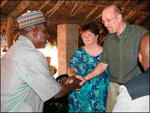 Dr. Thomas Asher, right, and Dr. Karen Asher, shown in Sierra Leone during an earlier trip, are co-founders of the Toledo-based West African Education and Medical Mission.