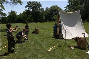 Kidsplay As Gage Winebernner, 10, left, takes a closer look at his wooden musket.