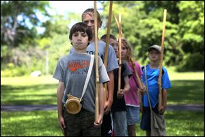 Gage Winebernner, 10, sucks in his stomach and throws his shoulders back as he leads a group of six soldiers.
