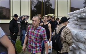 Ukrainian army soldiers leave  the administration building after they were released by officials of the self proclaimed 