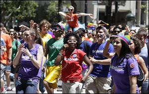 Facebook employees and family members march up Market Street during the 44th annual San Francisco Gay Pride parade Sunday in San Francisco. The lesbian, gay, bisexual, and transgender celebration and parade is one of the largest LGBT gatherings in the nation.