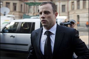 Oscar Pistroius arrives at court in Pretoria, South Africa, today. The murder trial resumed after one month during which mental health experts evaluated the athlete to determine if he has an anxiety disorder that could have influenced his actions on the night he killed his girlfriend Reeva Steenkamp.