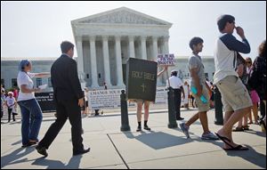 Demonstrators outside the Supreme Court in Washington try to get their messages out on abortion-rights as the justices handed down their decision on Monday.