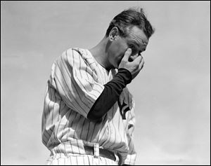 In this July 4, 1939, file photo, New York Yankee Lou Gehrig wipes away a tear while speaking during a tribute at Yankee Stadium in New York.