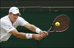 John Isner of the U.S. plays a return to Feliciano Lopez of Spain during their men's singles match at the All England Lawn Tennis Championships in Wimbledon today in London.