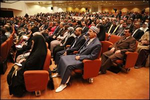 Newly elected parliament members attend the first session of parliament in the heavily fortified Green Zone in Baghdad, Iraq.