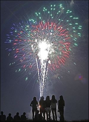 A group of girls stand on a mound at Fort Meigs to watch the fireworks during the Star Spangled Banner celebration last year in Perrysburg.
