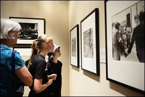From left, Karon Schockman, Sarai Starfeldt, 14, and Caleb Starfeldt, 12, view art at the 