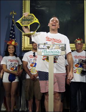 Seven-time hot dog eating champion Joey Chestnut poses while weighing in during a news conference today at City Hall in New York to promote the upcoming Nathan's Famous Fourth of July International Hot-Dog Eating Contest.