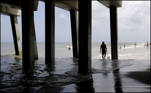 Tourists enjoy a calm ocean in Nags Head, N.C., Thursday. With all the tourists ordered out of the Outer Banks ahead of Hurricane Arthur, only the locals allowed to stay behind will go to bed with a category 2 storm rumbling past.