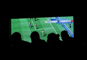 People watch a video game during the FIFA Interactive World Cup 2014 Grand Final at Sugar Loaf, Rio de Janeiro, Brazil, Thursday.