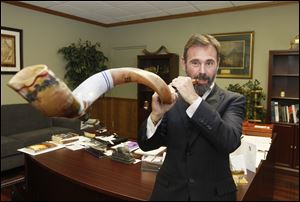 Rabbi Kirt Schneider blows the shofar. 