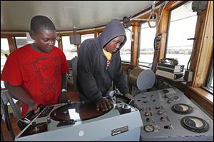 Justin Perry, 12, and his brother Christopher Perry, 13, of Fort Wayne, Ind., examine the pilot room of the S.S. Col. James M. Schoonmaker.